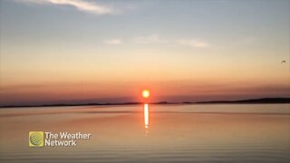 Serene sunset over still waters of Birchy Bay