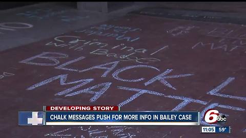 Protestors use chalk messages to demand justice for Aaron Bailey, man shot by IMPD in June