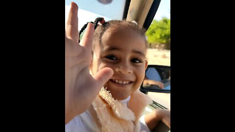 Little Girl Giving Peace laughing And Playing In The Car