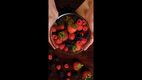 #🫐🍓🍒Red berries served in a bowl on a wooden table#🍒🫐🍓