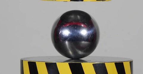 HYDRAULIC PRESS AGAINST STEEL BALL.