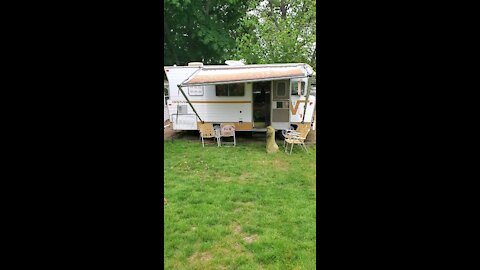 The outside of our 1973 Winnebago Brave D18, as my Fiancé does it's first oil change