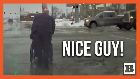 Police Officer Helps Man in Wheelchair Cross Road in Slippery Conditions