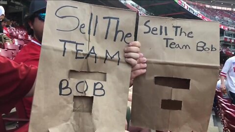 Reds fans wear brown paper bags over heads at game