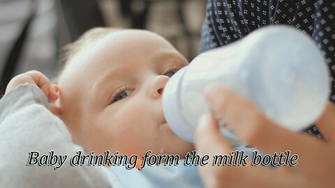 Baby drinking form the milk bottle