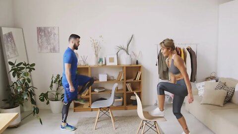 Couple Doing Step Aerobics Using Chairs