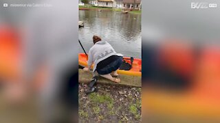 Woman falls as she tries to get into kayak