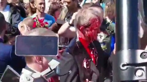 The Russian ambassador, Sergey Andreyev doused with red paint at a Soviet cemetery