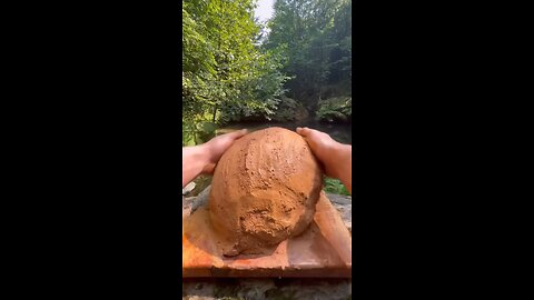 Black Sea Explorer Cooking Chicken in Primitive Mud in Forest