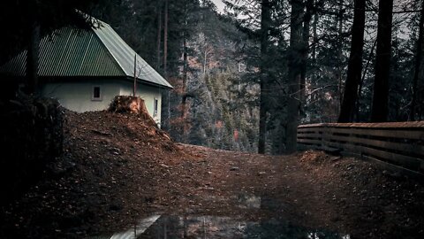 Rain on a tin roof of a house near a gravel path in rural Karpaten