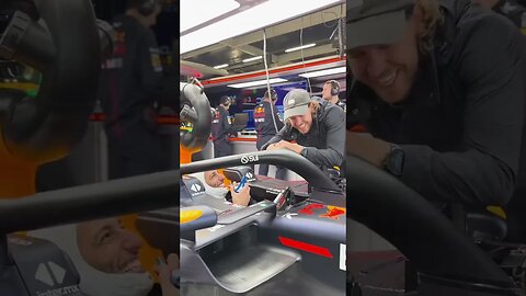 Seb serving coffee to Daniel in the Red Bull garage