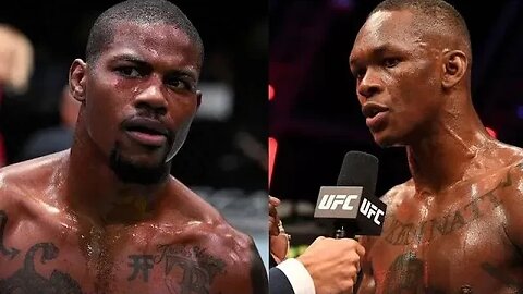 Israel Adesanya argues with Kevin Holland from the side of the octagon