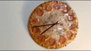 Watch a clock a being made from pizza