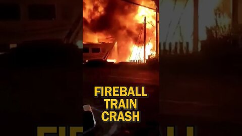 Flames erupt after train collides with truck