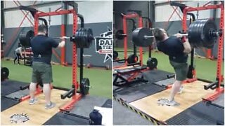 Strongman falls backwards doing overhead press