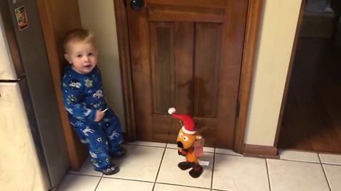 "A Tot Boy Dances With A Dancing Christmas Toy"