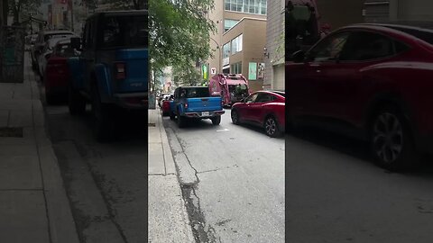 Garbage truck collector in action downtown Montréal