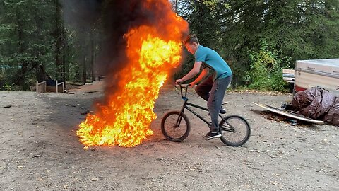 Dumb kid rides bike through fire (gets burned)