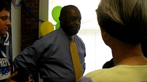 Herman Cain presses the flesh at his NH HQ 1.