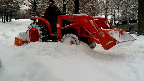 Kubota L2501 plowing snow.