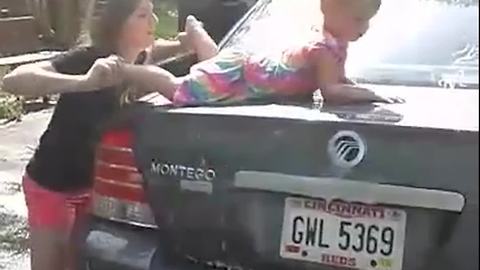 HILARIOUS: Girl Uses Her Baby Sister Instead of Sponge to Wash Car