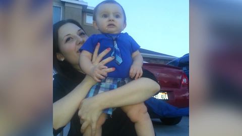 A Baby Boy Frowns While He Watches Fireworks