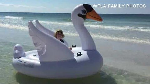 Mom and sun drift away on giant inflatable swan