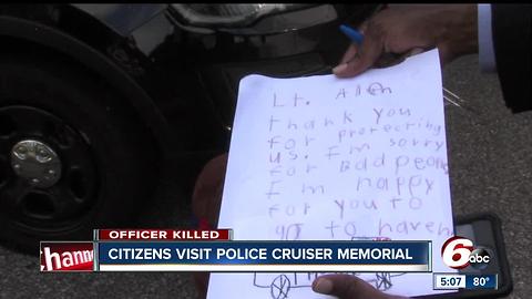 Citizens visit police cruiser memorial of Lt. Aaron Allan