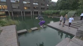 Parkour athlete misjudges leap and gets a soaking