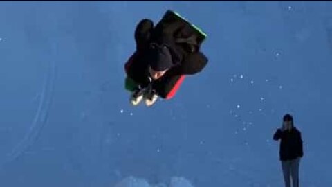 Young man pulls off backflip on sleigh!