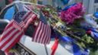 The late Sgt. Johnson's patrol car sits as a memorial outside Saint Francis Hospital