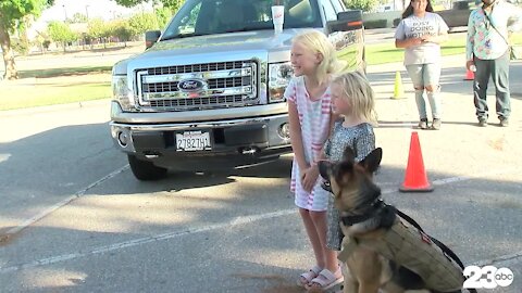 Community members accept dog food donations for local shelters in honor of K-9 Officer Jango