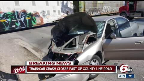 Crash involving train and car closes busy Indianapolis road