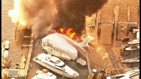 Boat owner watches anxiously as nearby yacht burns