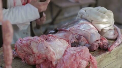 Butcher cuts meat of pork