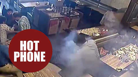 Moment a man's shirt goes on fire in a restaurant - after his mobile phone explodes in his pocket