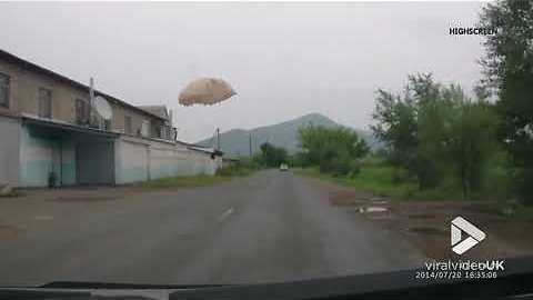 Parachutist lands on road