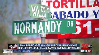 Man barricades himself inside burning home