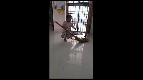 Cute little baby learning to clean home