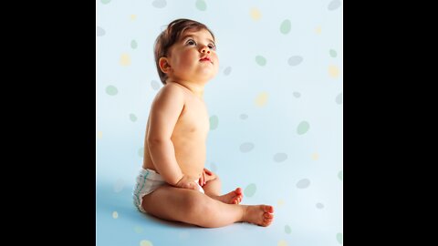 adorable baby girl eating a sour piece of fruit at home