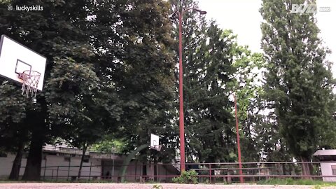 Guy nails basketball hoop with amazing shot