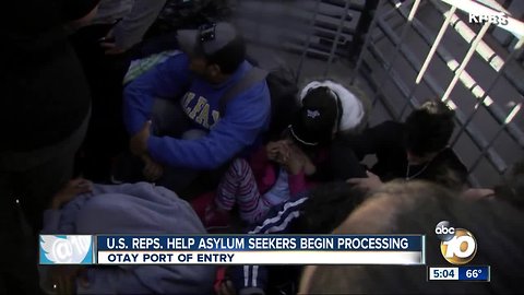 U.S. congressional delegation help asylum seekers begin processing