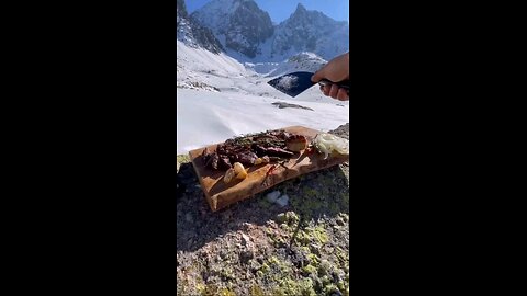 Black Sea Explorer Cooking Rib-Eye on Snowy Peak