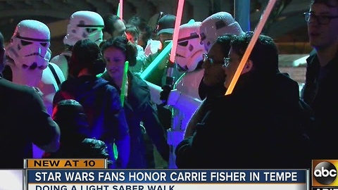 Fans gather to remember Carrie Fisher with light saber walk