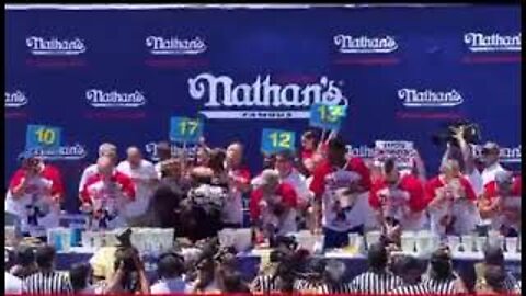 Hot Dog Eating Champ Joey Chestnut Chokes Out Animal Rights Protester,with mouthful of dogs