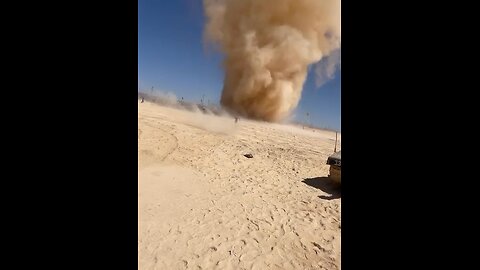 Men run toward massive dust devil