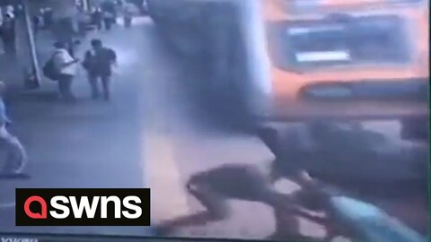 Policeman saves the life of a passenger crossing a railway line in front of a train