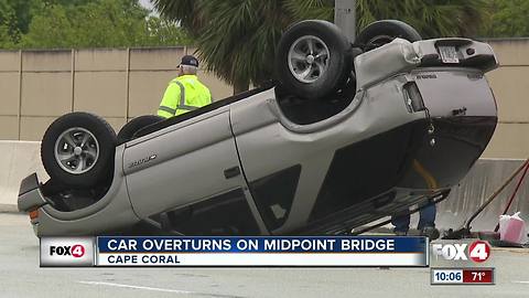 Emergency crews assist overturned vehicle on Midpoint Bridge