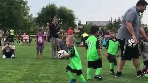 Boy Carries Soccer Ball To Goal