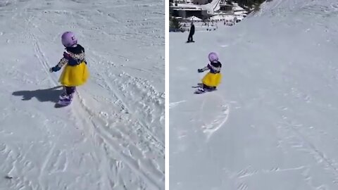 Little Girl Shows Impressive Heels Side Turn While Snowboarding